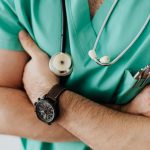 Crop doctor with stethoscope in hospital